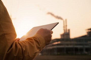 Operator using a tablet while observing industrial terminal equipment