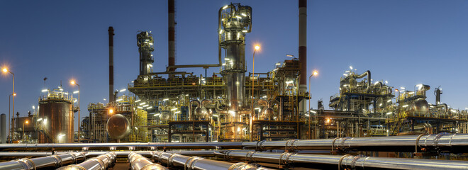 Petroleum pipelines and terminal infrastructure illuminated at night