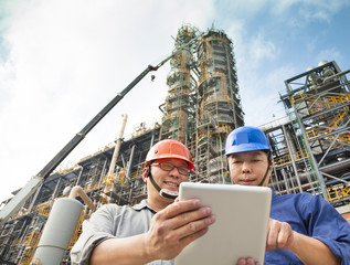 Two terminal personnel reviewing operating information on a digital tablet